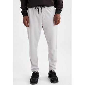 Pantaloni sport slim fit cu slituri cu fermoar la glezna