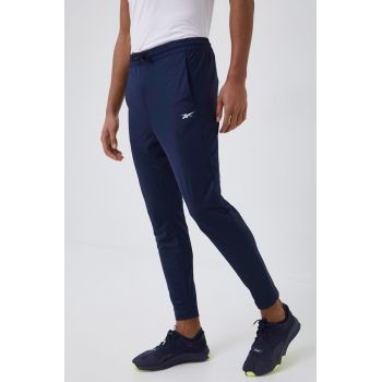 Reebok pantaloni de trening barbati, culoarea albastru marin, neted de firma originali