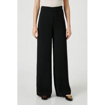 Pantaloni cu croiala ampla si talie inalta