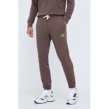 New Balance pantaloni de trening culoarea maro, neted de firma originali