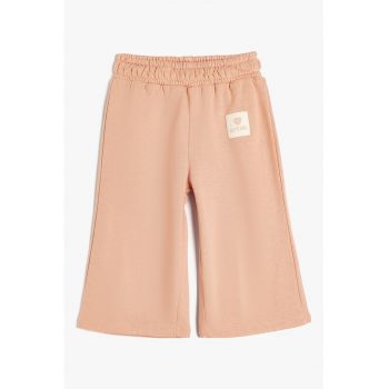 Pantaloni ampli cu banda elastica in talie
